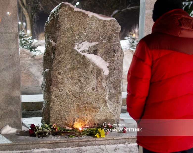 Жители Томска несут цветы к Камню скорби после новостей о смерти Навального